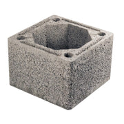 A gray concrete Schiedel DM 44 chimney block with multiple circular holes on the side facing up.