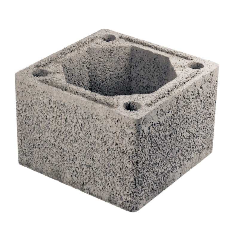 A gray concrete Schiedel DM 44 chimney block with multiple circular holes on the side facing up.
