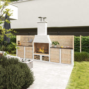 Outdoor kitchen with fireplace and wooden cabinets in a garden setting
