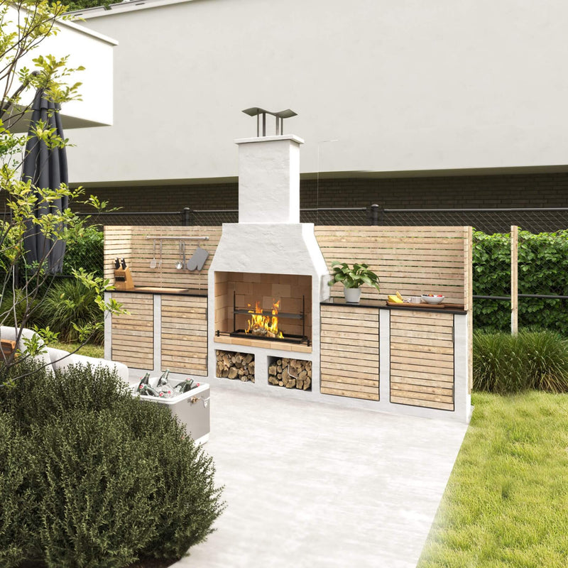 Outdoor kitchen with fireplace and wooden cabinets in a garden setting