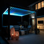 Outdoor patio area with illuminated pergola and seating