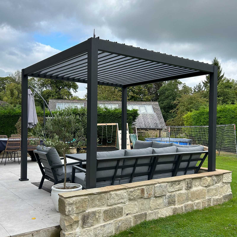 Garden pergola with outdoor furniture under a cloudy sky