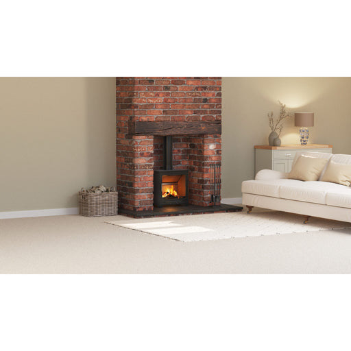 Living room with a brick fireplace and beige sofa.