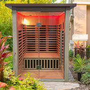 Wooden sauna with red interior light, surrounded by greenery