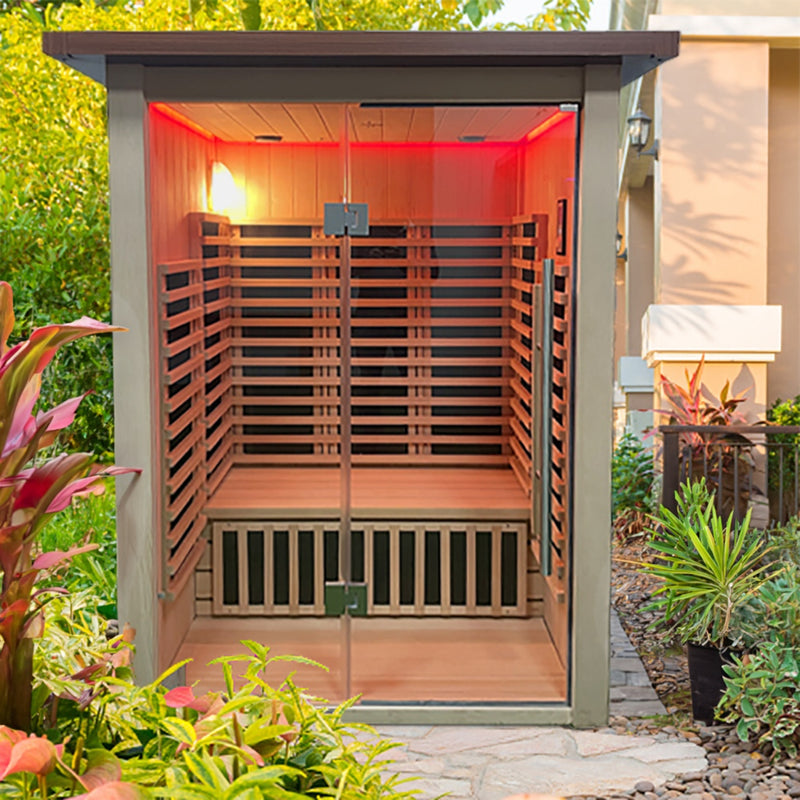 Wooden sauna with red interior light, surrounded by greenery